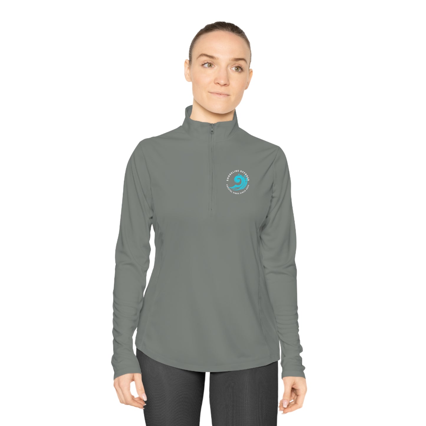a woman wearing a gray shirt and black pants