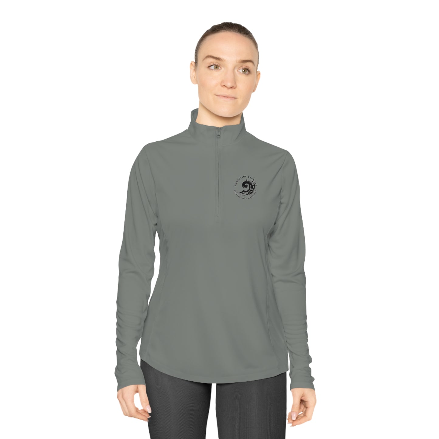 a woman wearing a gray shirt and black pants