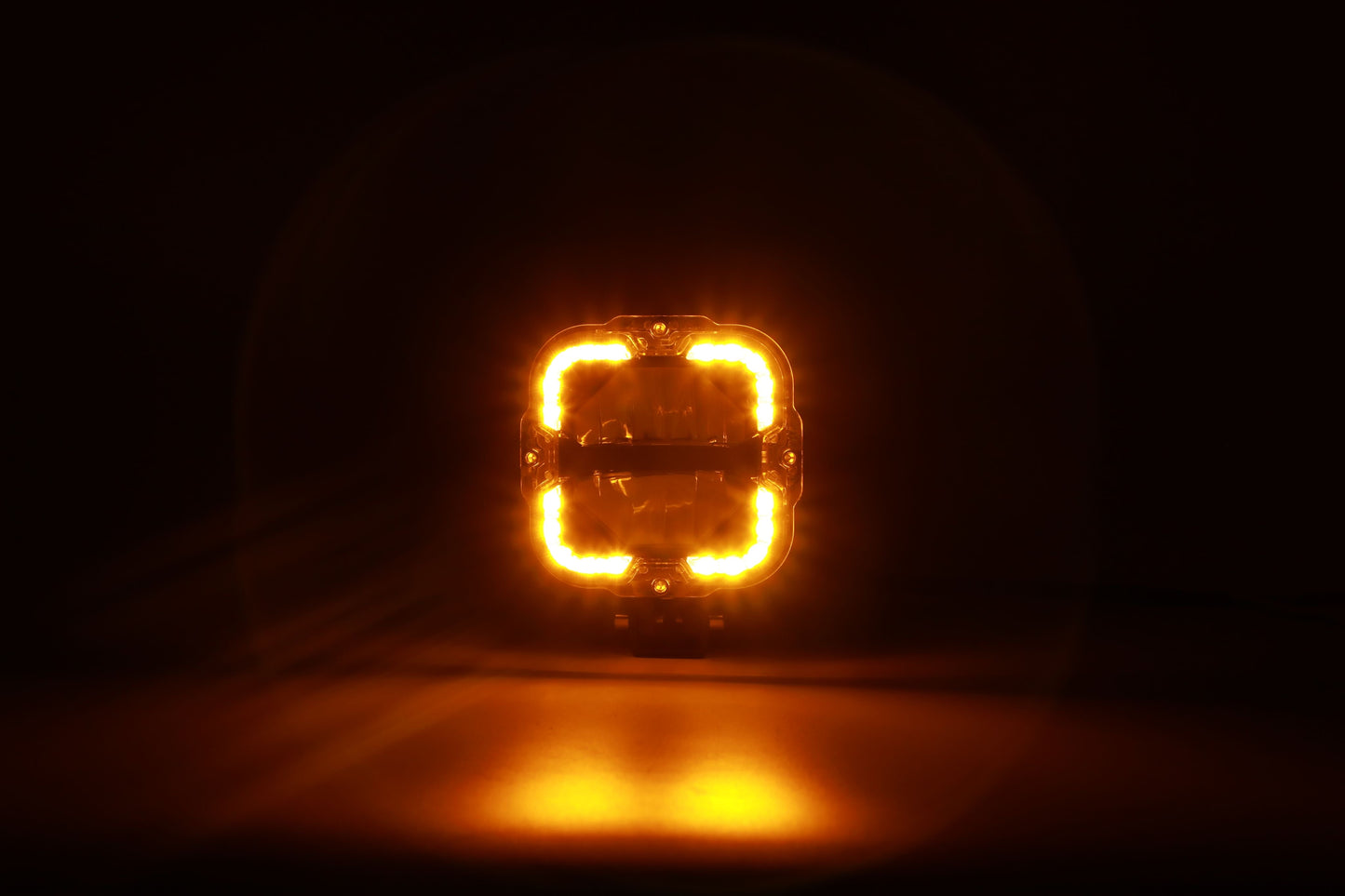 The Shoreline Offroad Pro Series Bright White LED 4” Pods with Amber DRL illuminated in amber light, accentuating their visibility in dark conditions. These powerful lighting accessories, perfect as ditch lights and rock lights, embody the ultimate combination of Bright white and functional design for offroad enthusiasts.