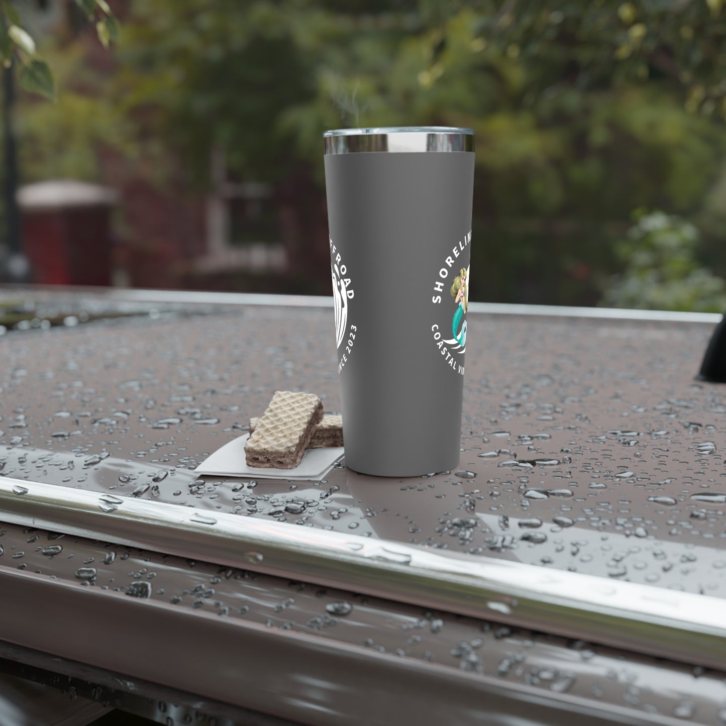 a cup of coffee sitting on top of a car