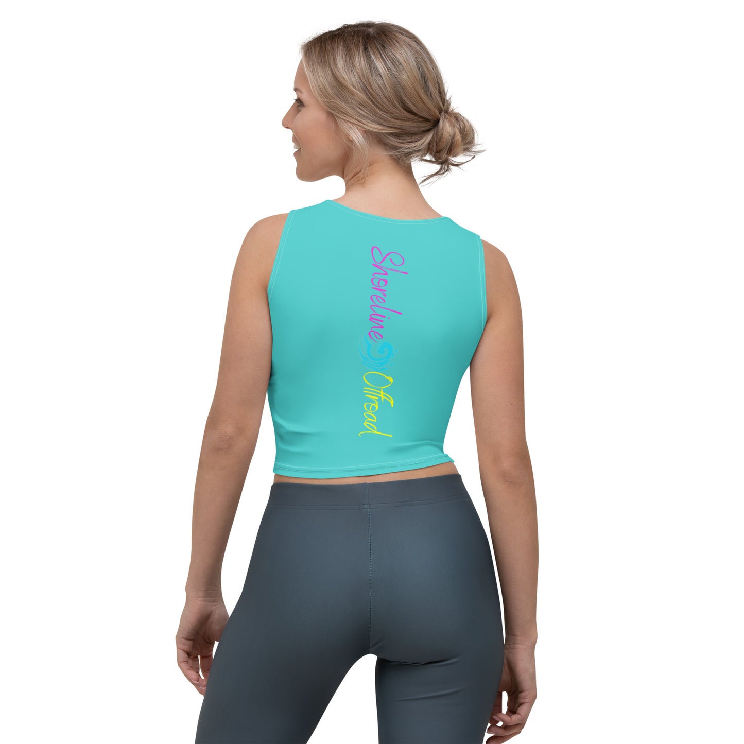 a woman wearing a turquoise crop top with the word love on it