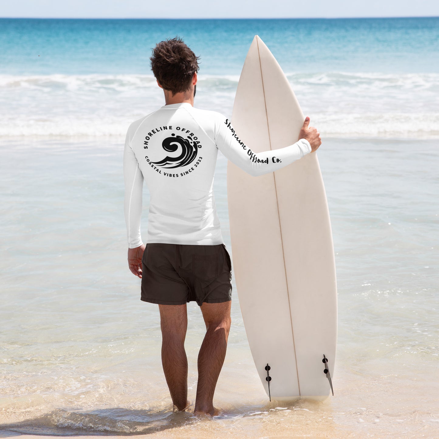 a man holding a surfboard on the beach