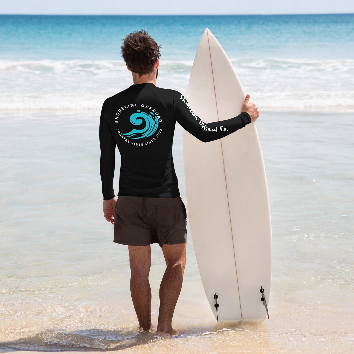a man in a wet suit holding a surfboard