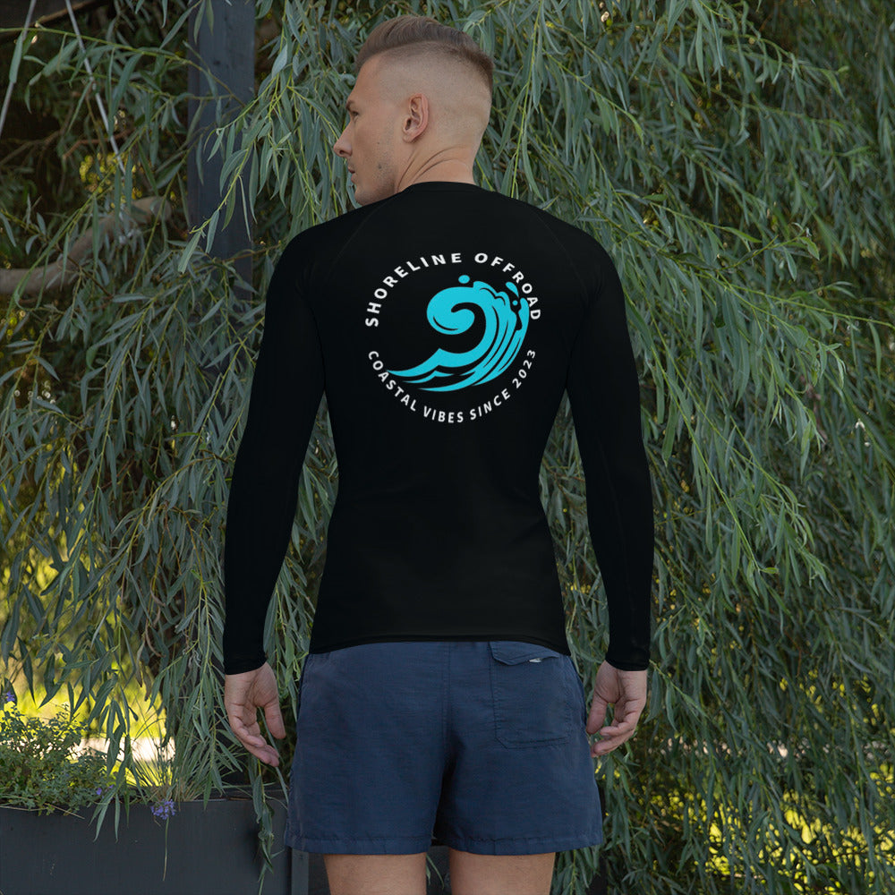 a man in a wet suit standing in front of a tree