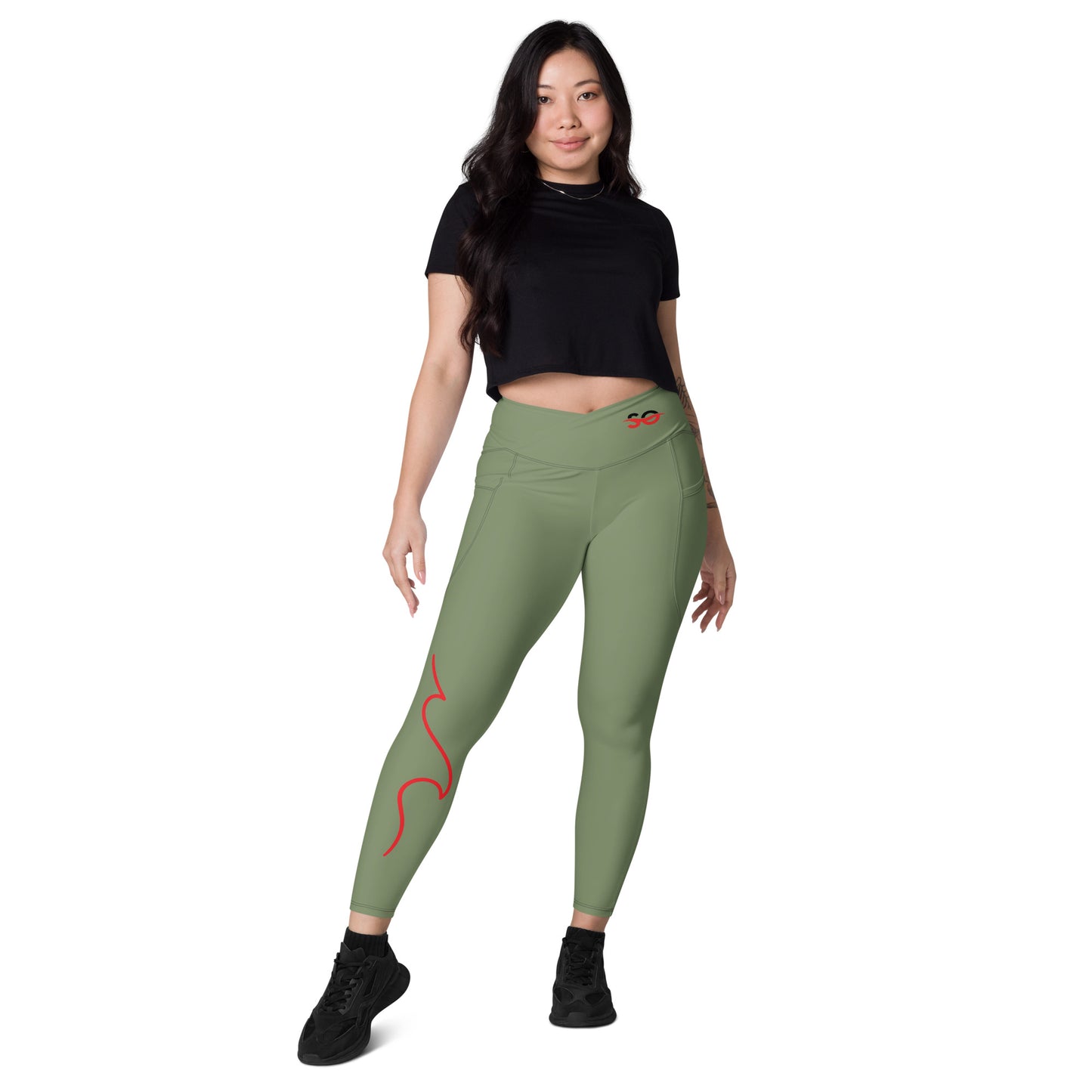 a woman in a black top and green leggings