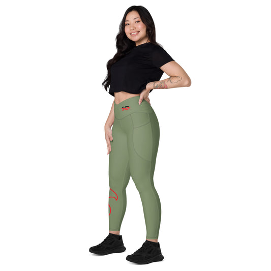 a woman in a black top and green leggings