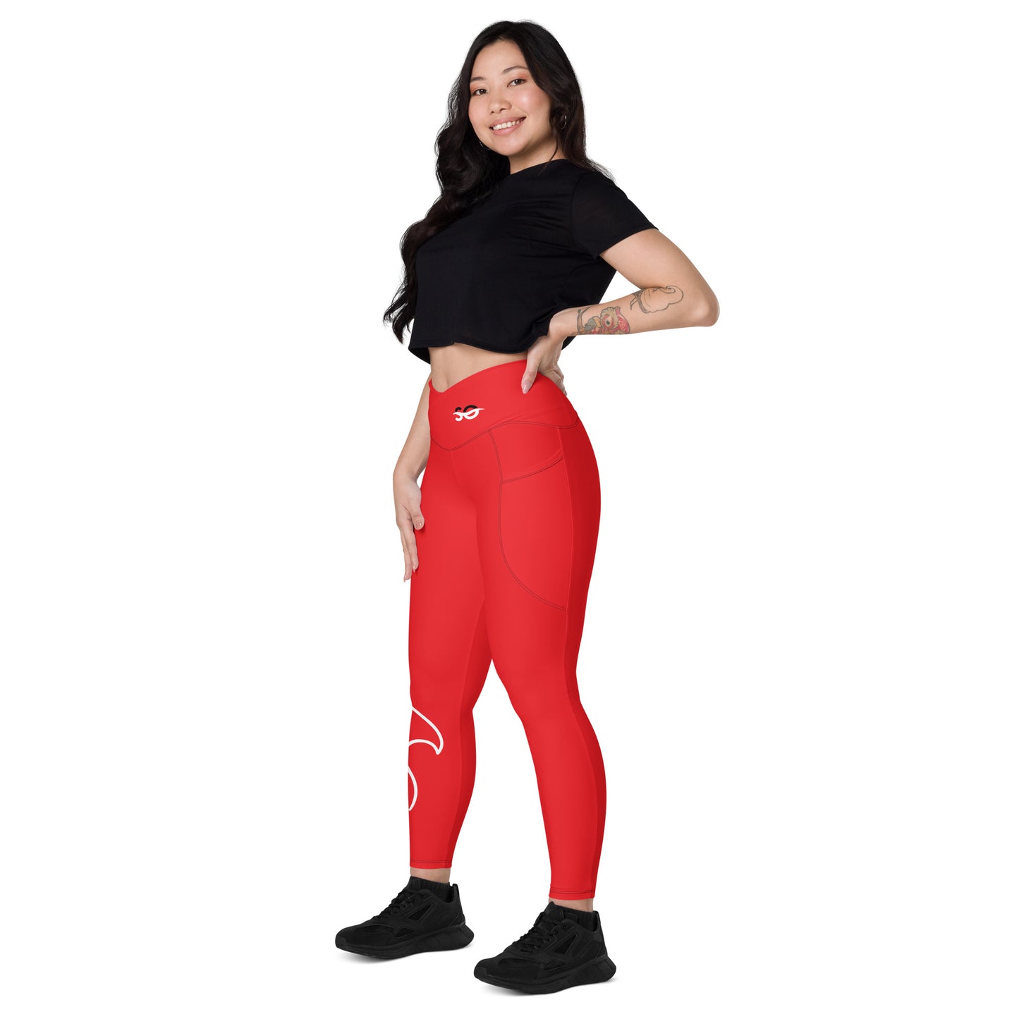 a woman in a black top and red leggings