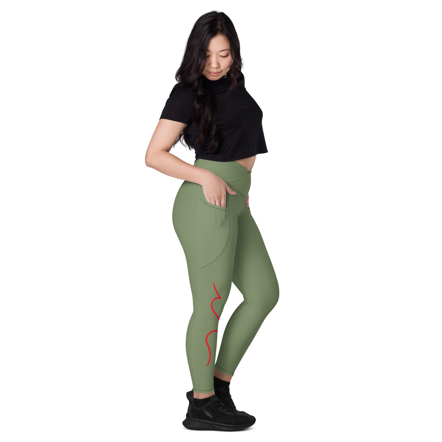 a woman in a black top and green leggings