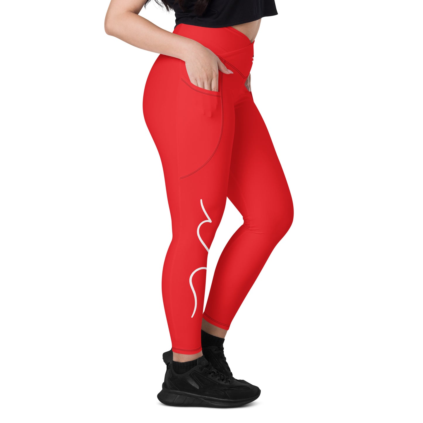 a woman in a black top and red leggings