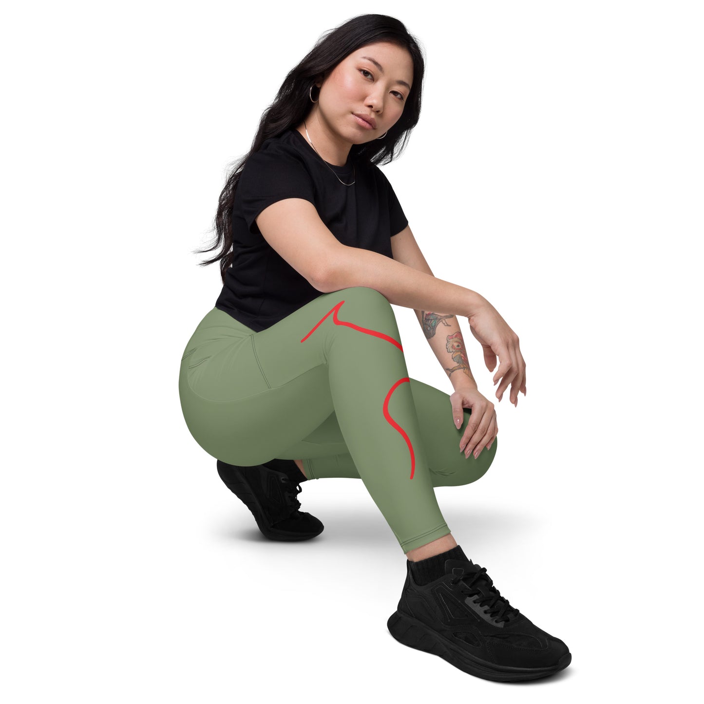 a woman in black shirt and green leggings