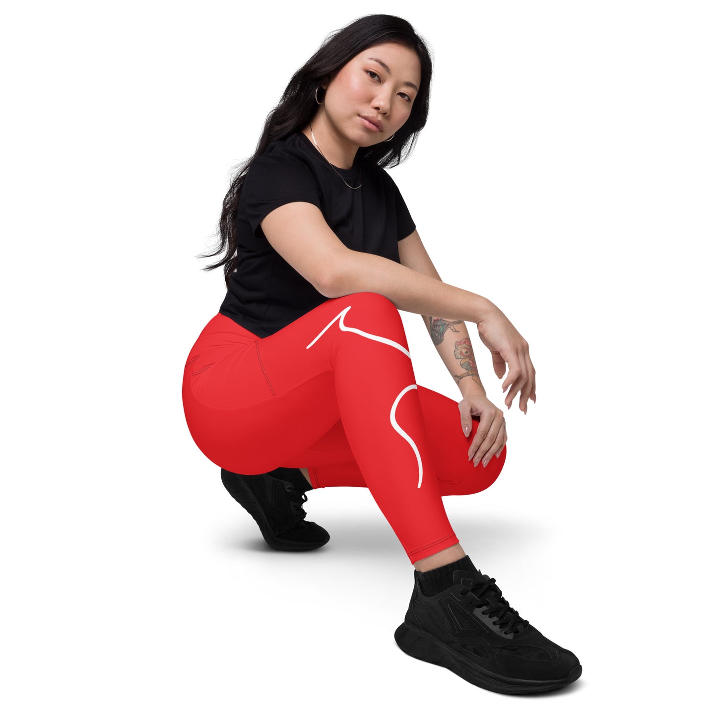 a woman in a black shirt and red leggings