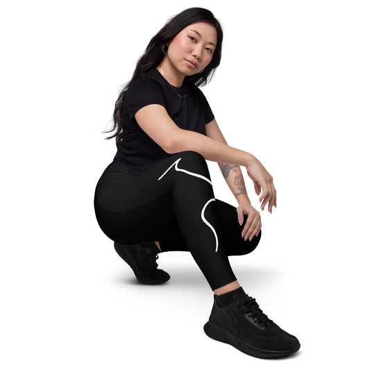a woman squatting down in a black shirt and black leggings