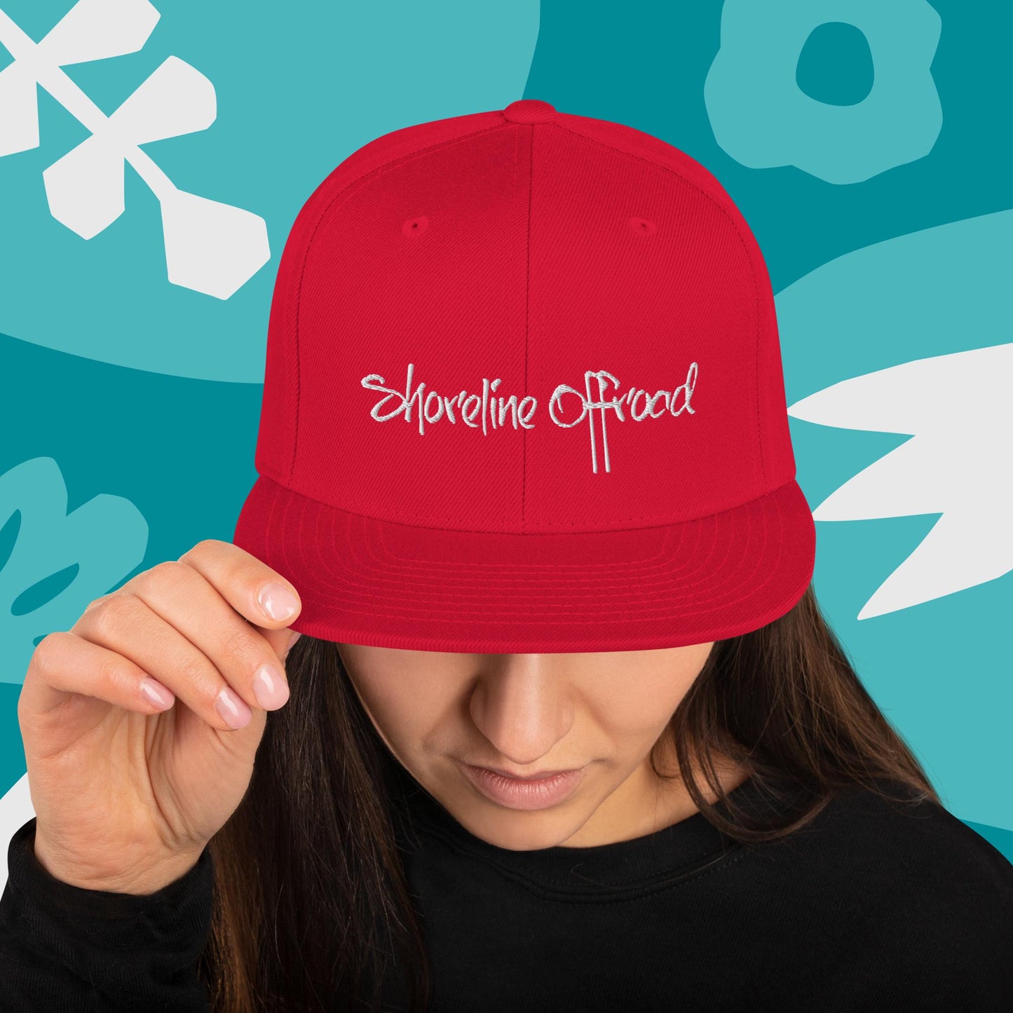 a woman wearing a red hat with the word shoreline road on it