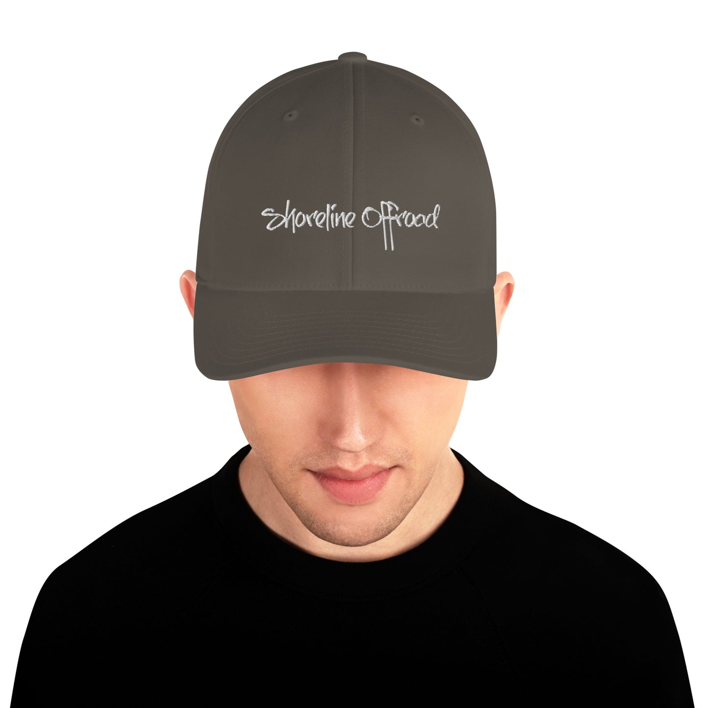 a man wearing a hat with the words shoreline road on it