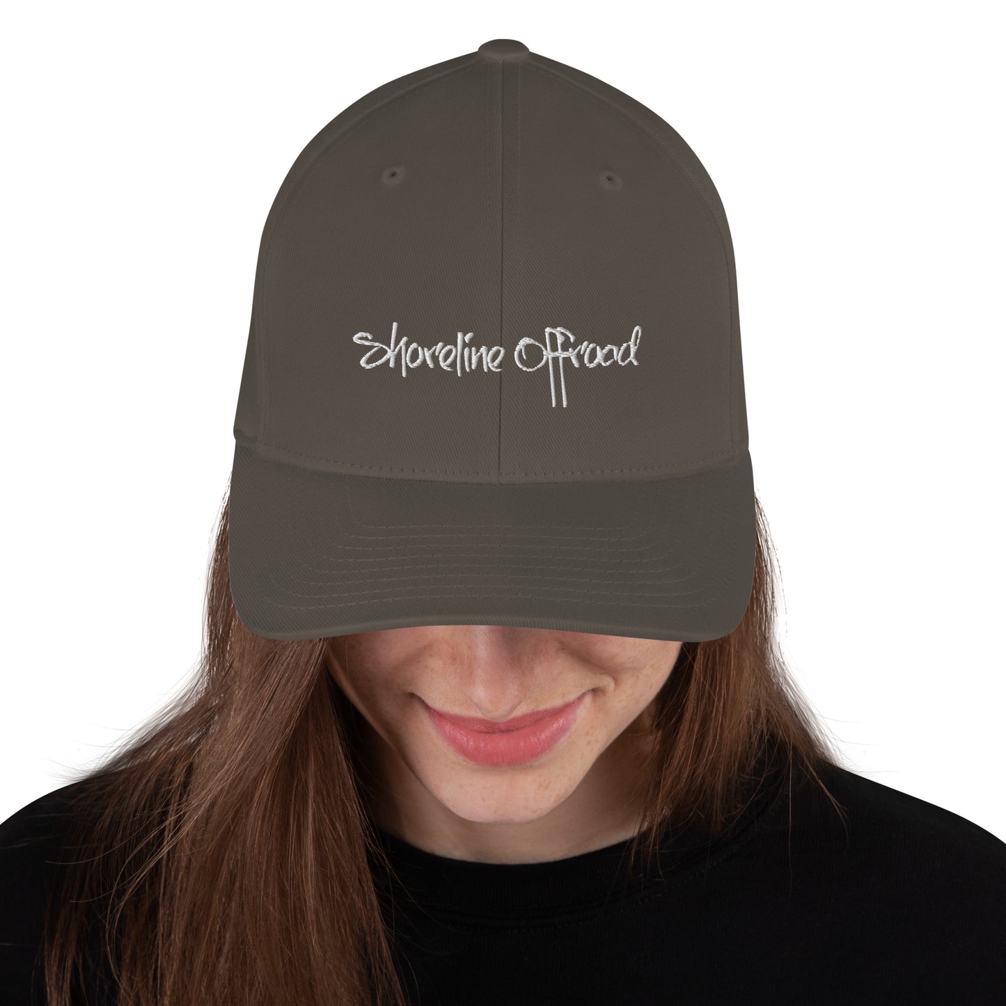 a woman wearing a hat with the words shoreline road on it