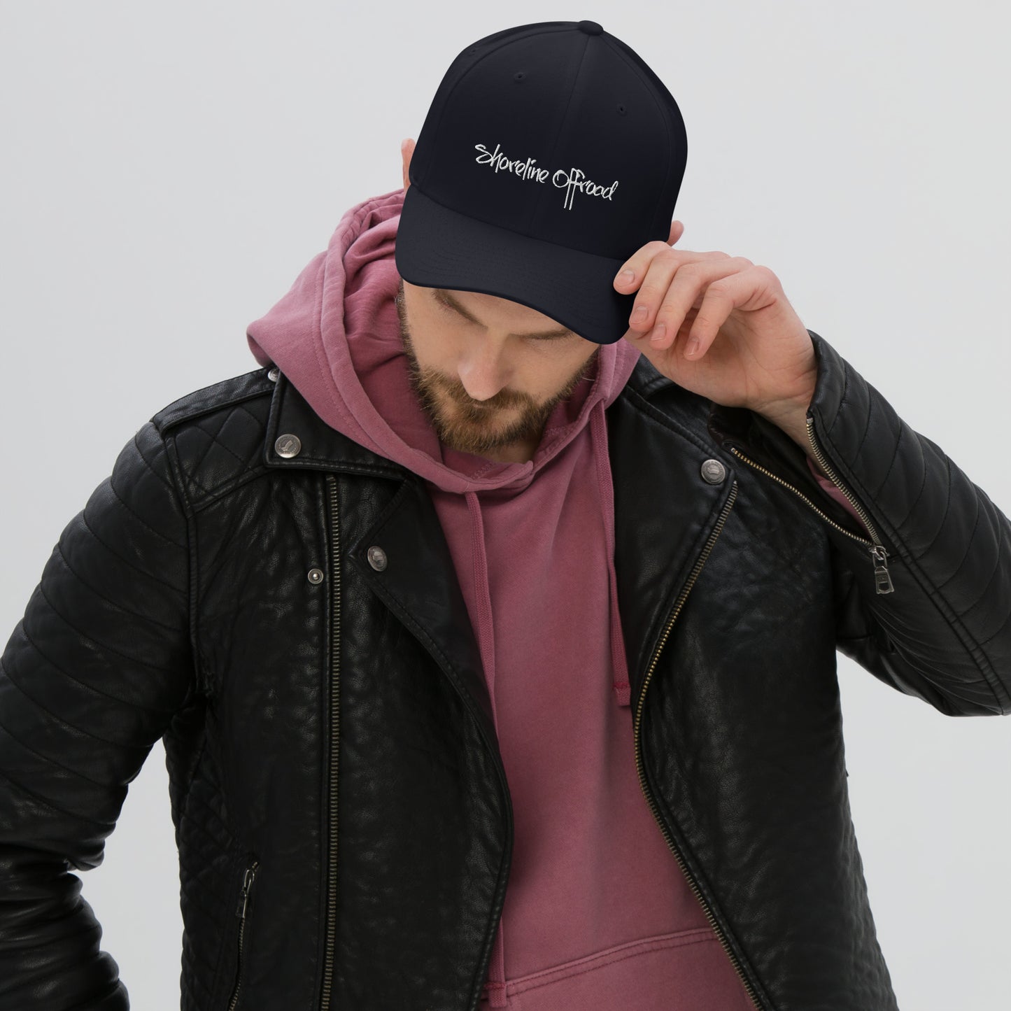 a man wearing a black hat and a pink shirt