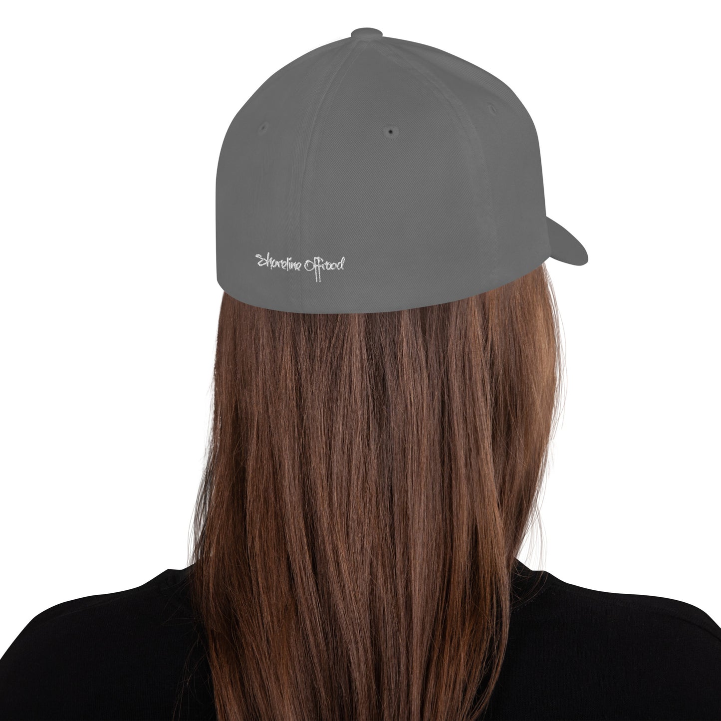 a person with long hair wearing a grey hat