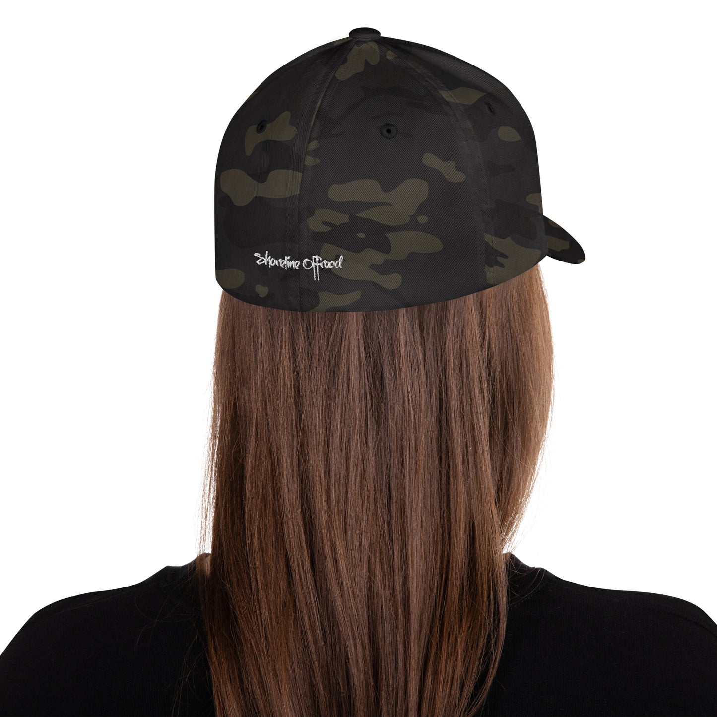the back of a woman's head wearing a camo hat