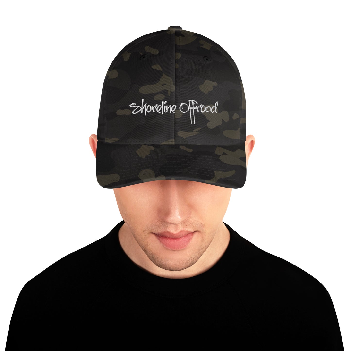 a man wearing a black camo hat with white embroidered logo