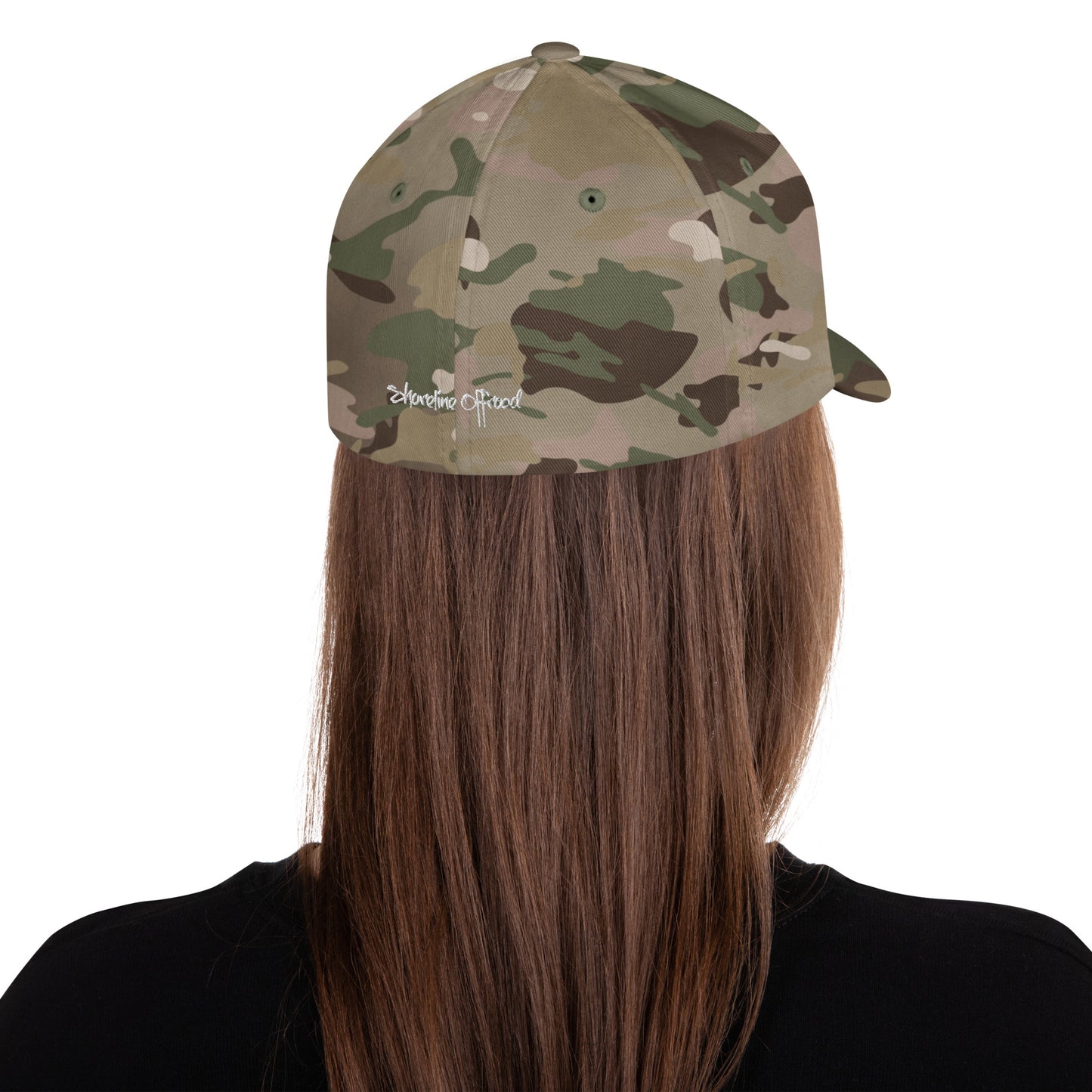 a woman with long hair wearing a camo hat