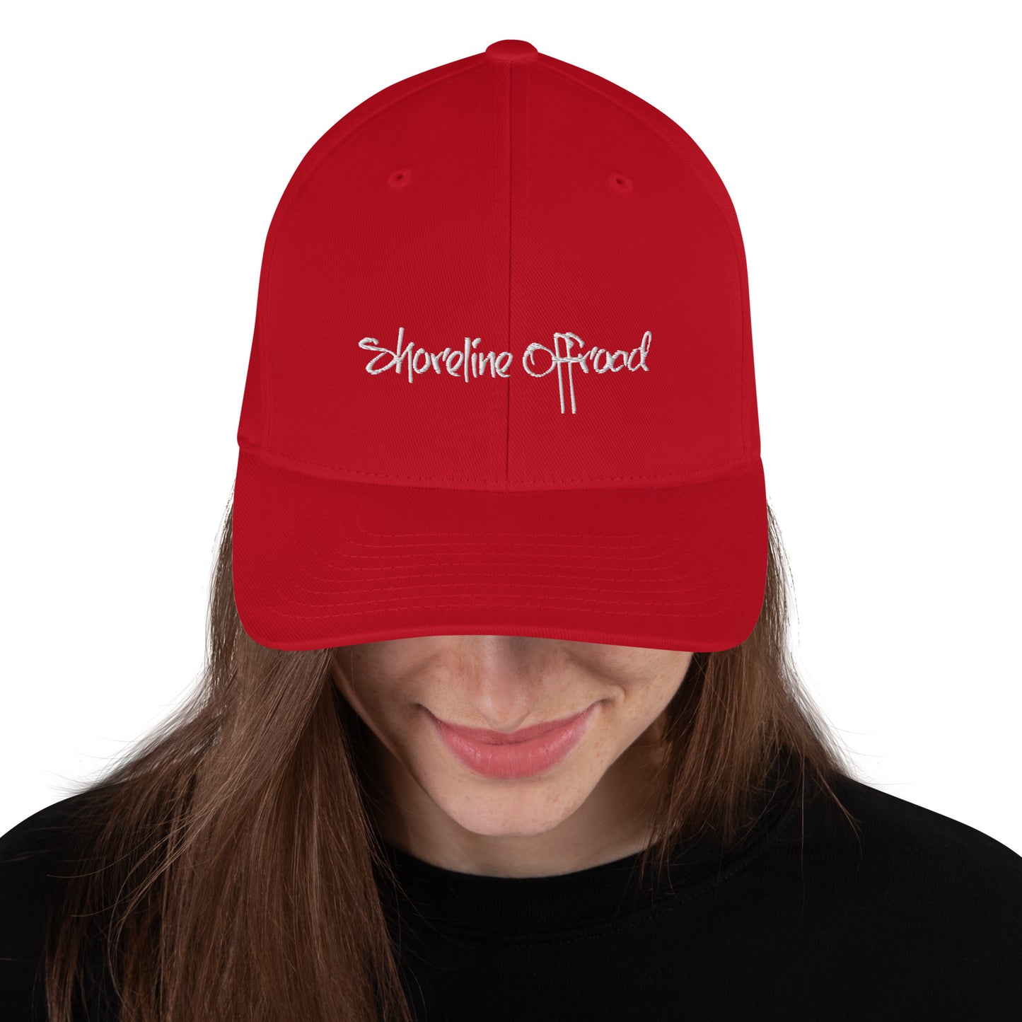a woman wearing a red hat with the word shoreline offroad written on it