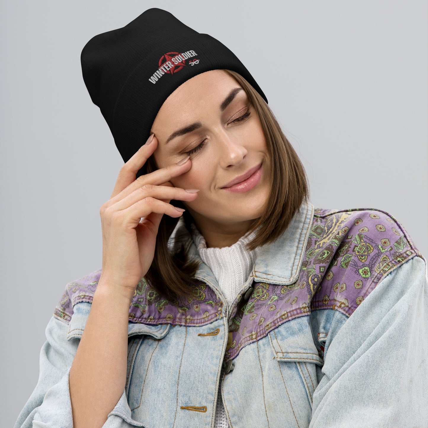 a woman in a denim jacket is talking on a cell phone