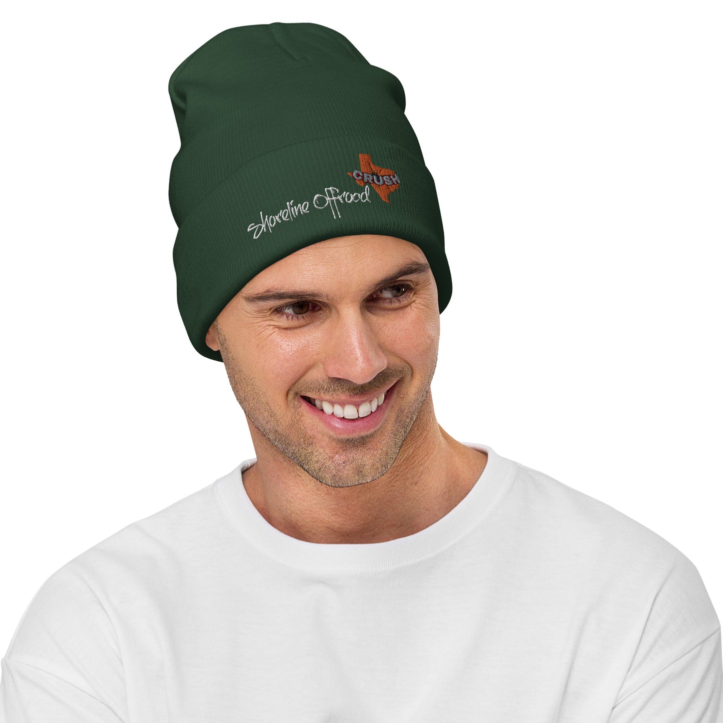 a man wearing a green beanie with a red and white embroidered on it