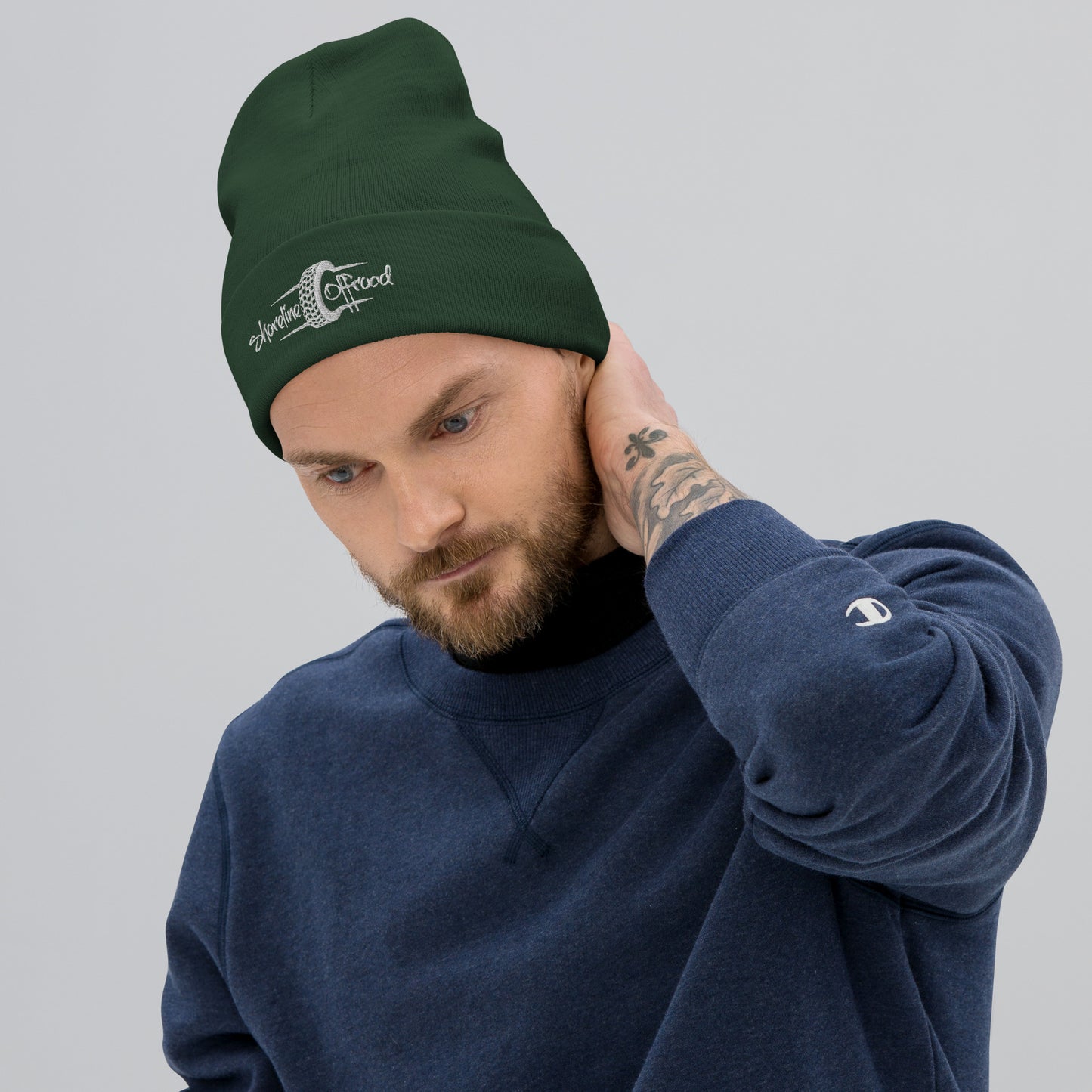 a man with a beard wearing a green beanie