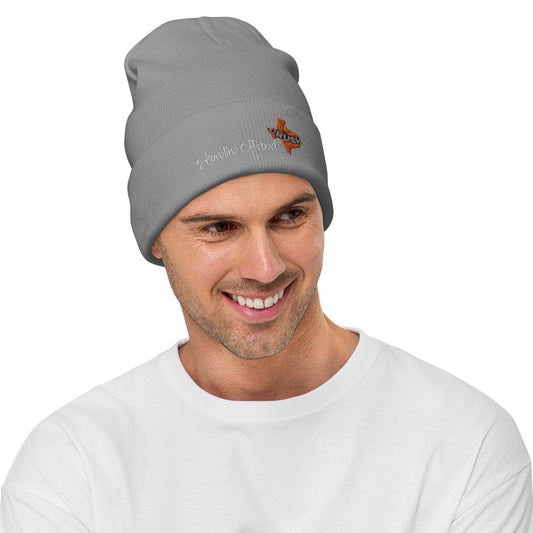 a smiling man wearing a gray beanie hat