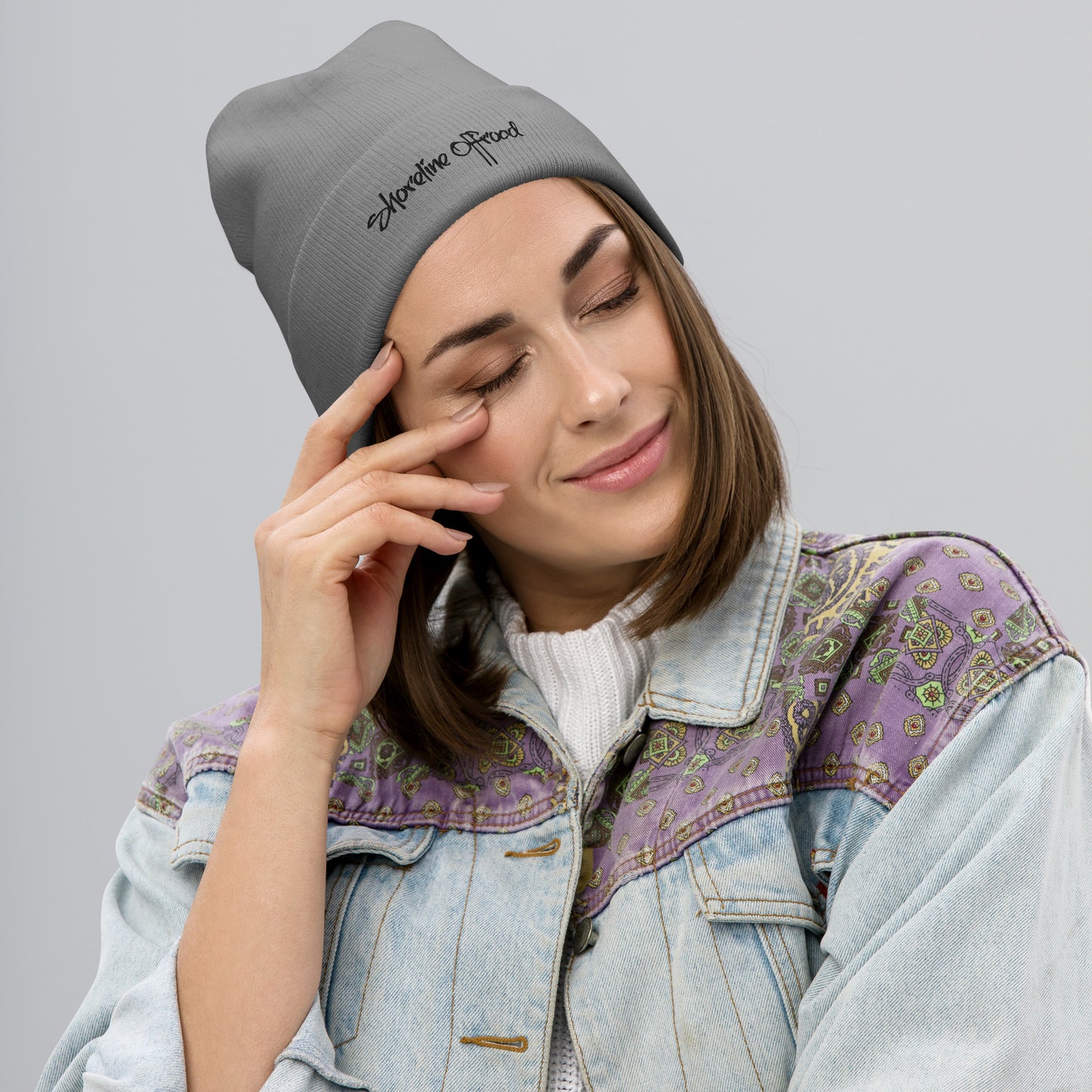 a woman in a denim jacket talking on a cell phone