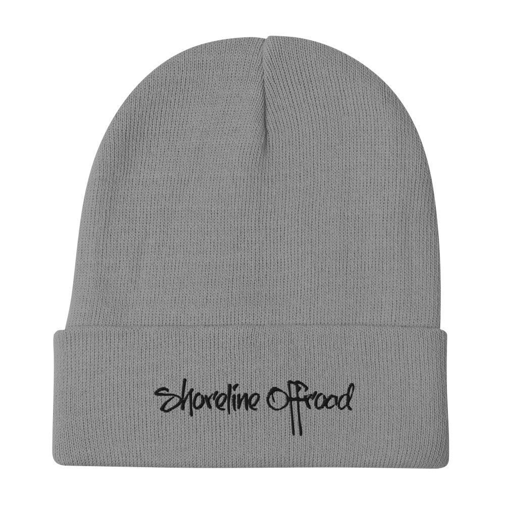 a grey beanie with the word shoreline on it
