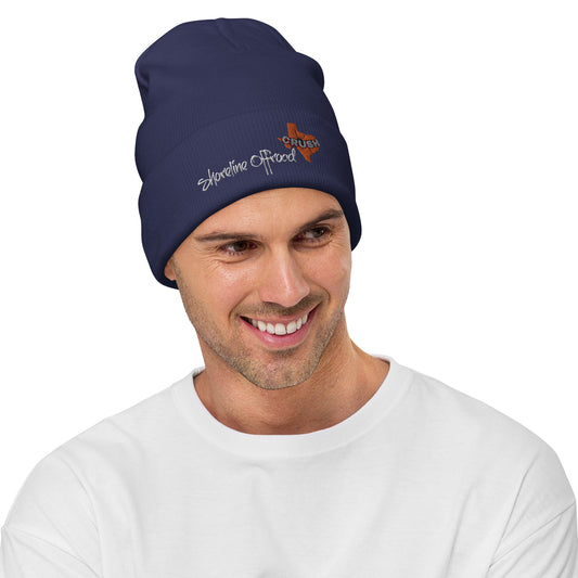 a man wearing a beanie hat with a logo on it