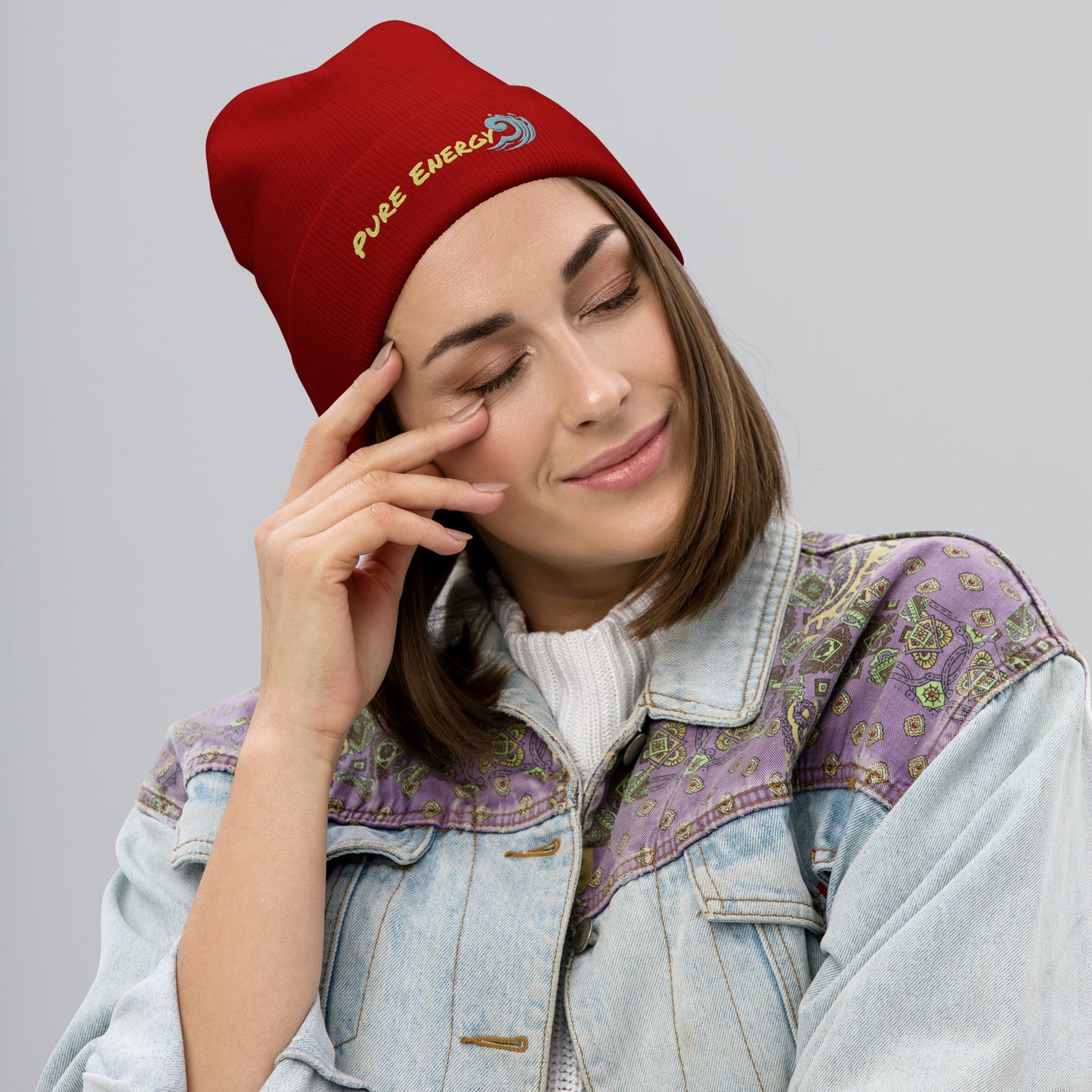 a woman wearing a red beanie talking on a cell phone