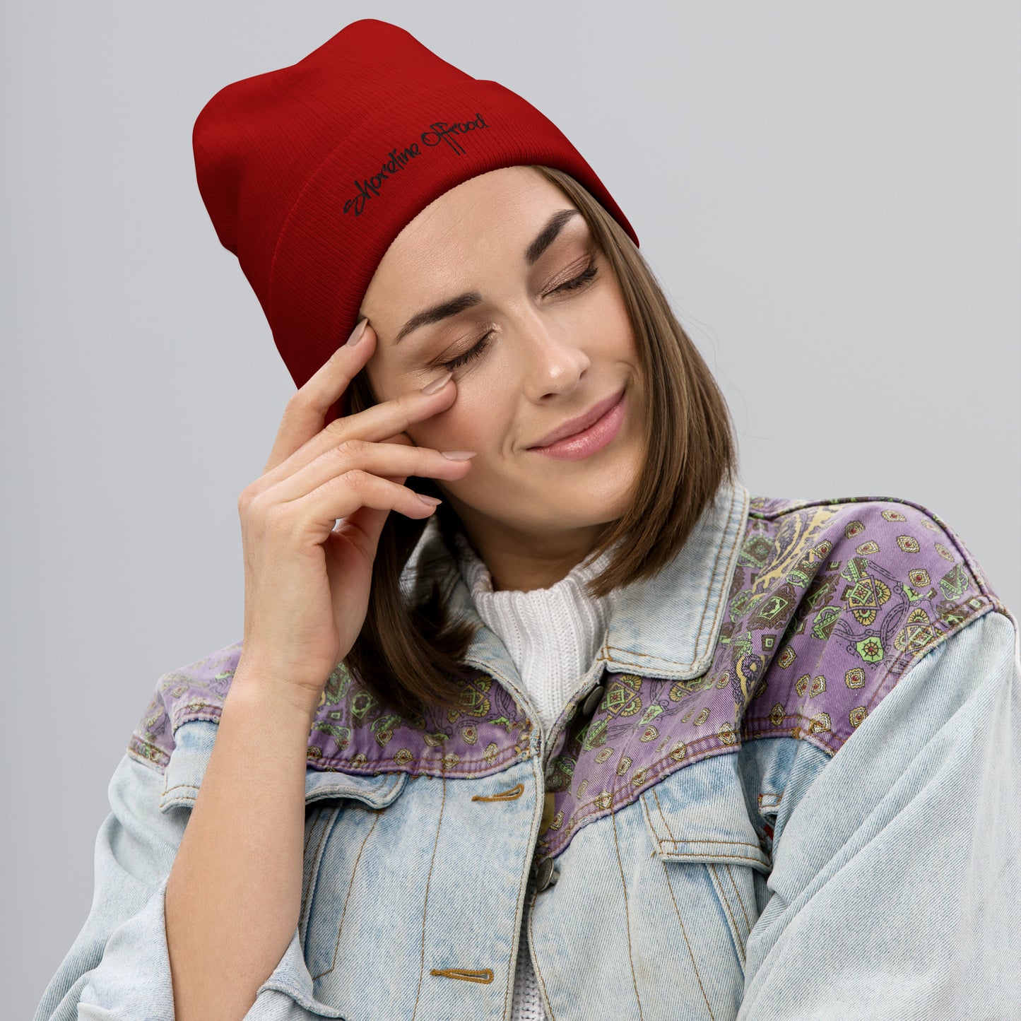 a woman wearing a red beanie talking on a cell phone