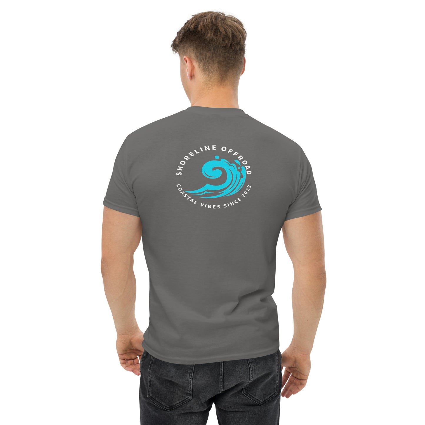 a man wearing a grey t - shirt with a blue wave on it