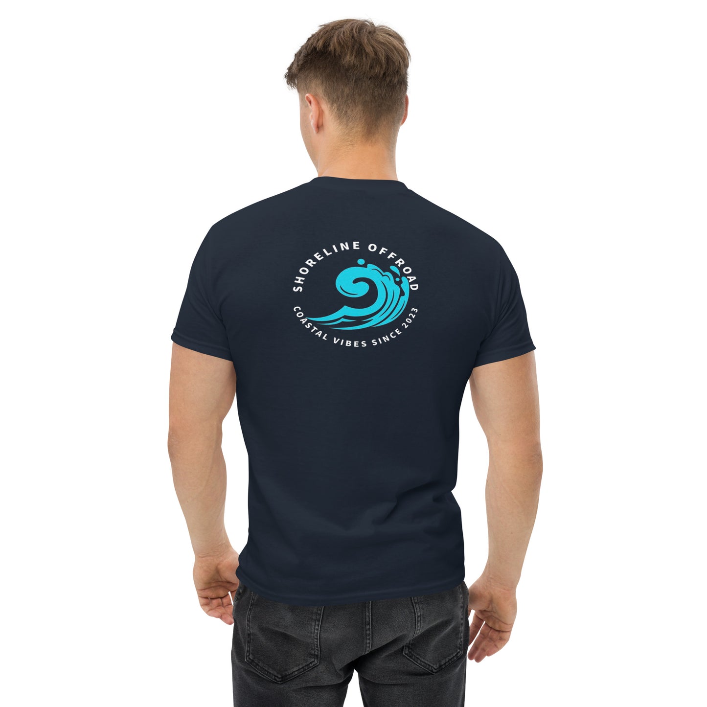 a man wearing a dark blue t - shirt with a wave on it