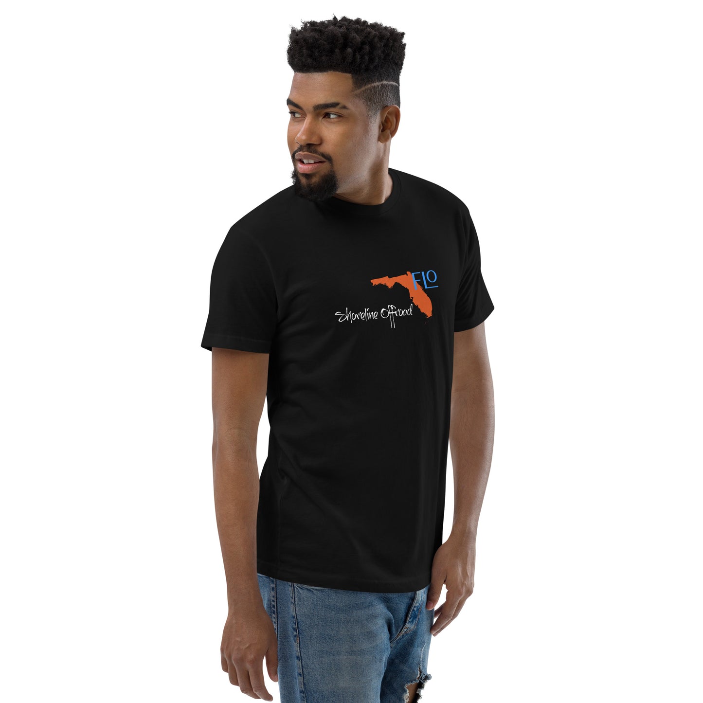 a man wearing a black t - shirt with an orange gun on it