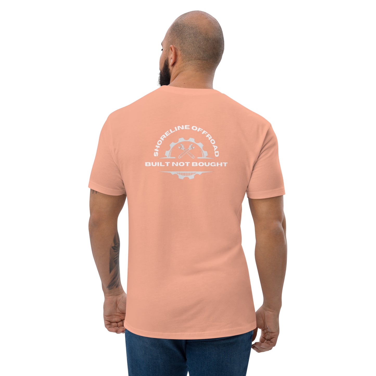 a man wearing an orange shirt with a white logo on it