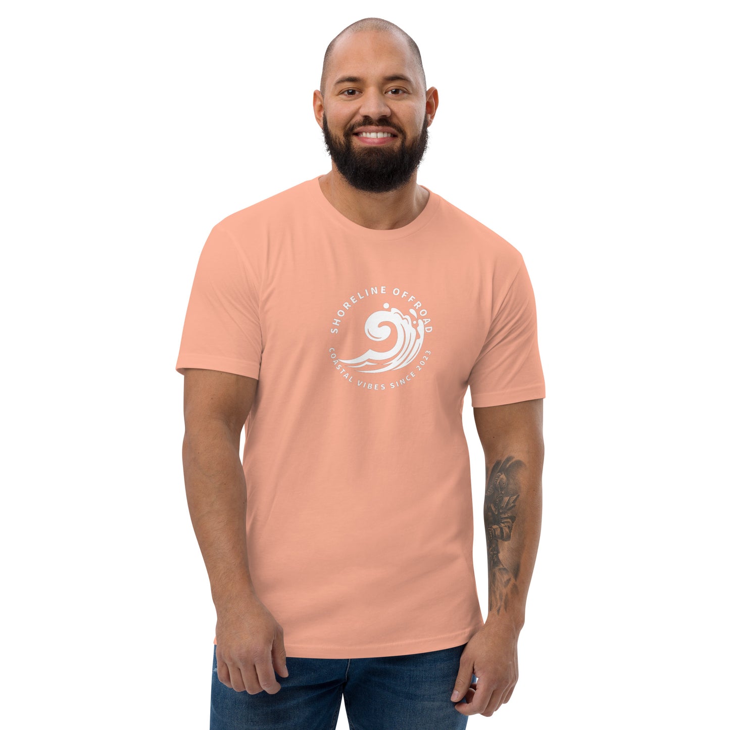 a man with a beard wearing a pink t - shirt