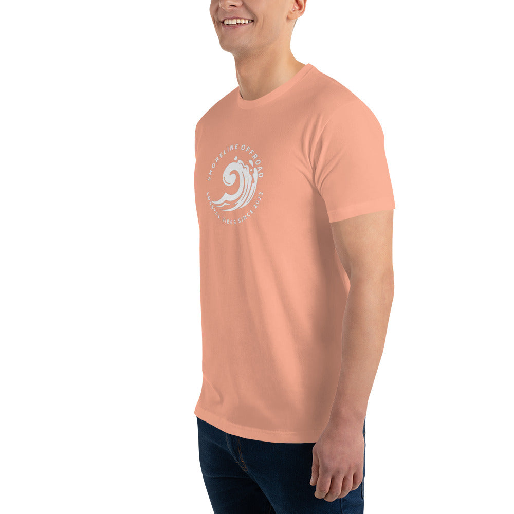 a man in an orange shirt smiles at the camera