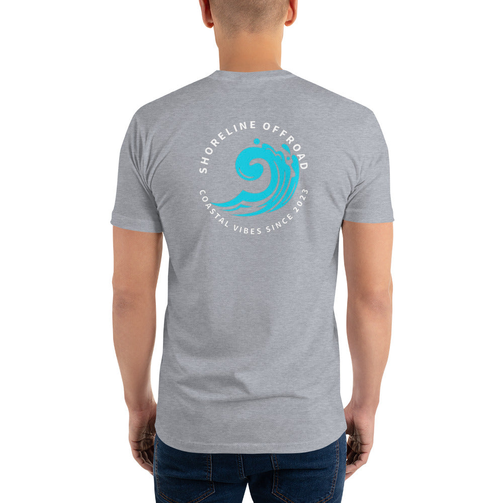 a man wearing a grey t - shirt with a blue wave on it