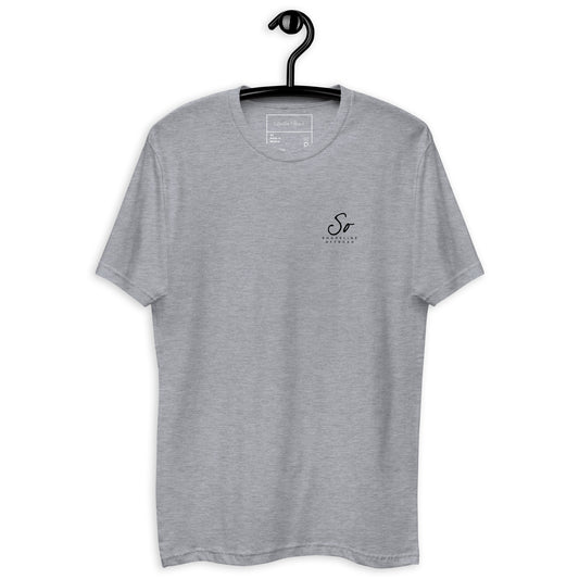 a grey t - shirt hanging on a hanger