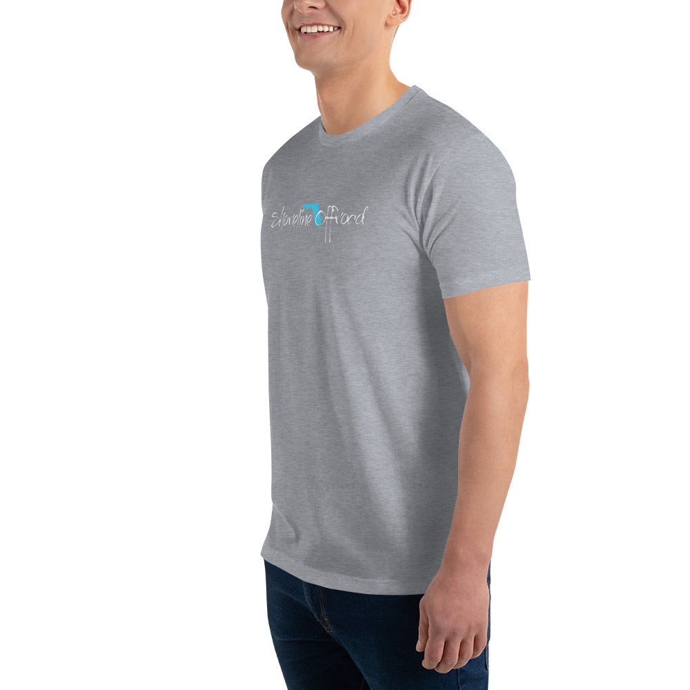 a man in a grey shirt smiles at the camera