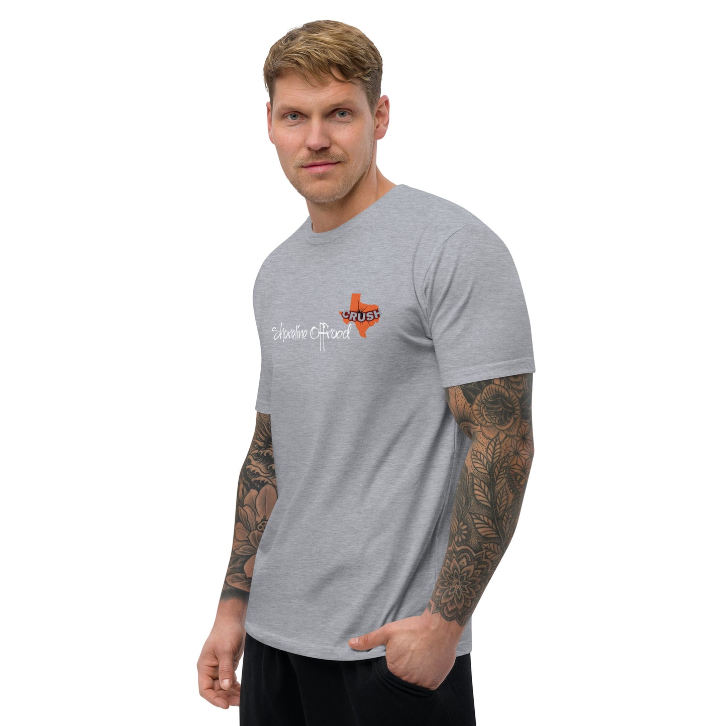 a man wearing a grey t - shirt with an orange cross on it