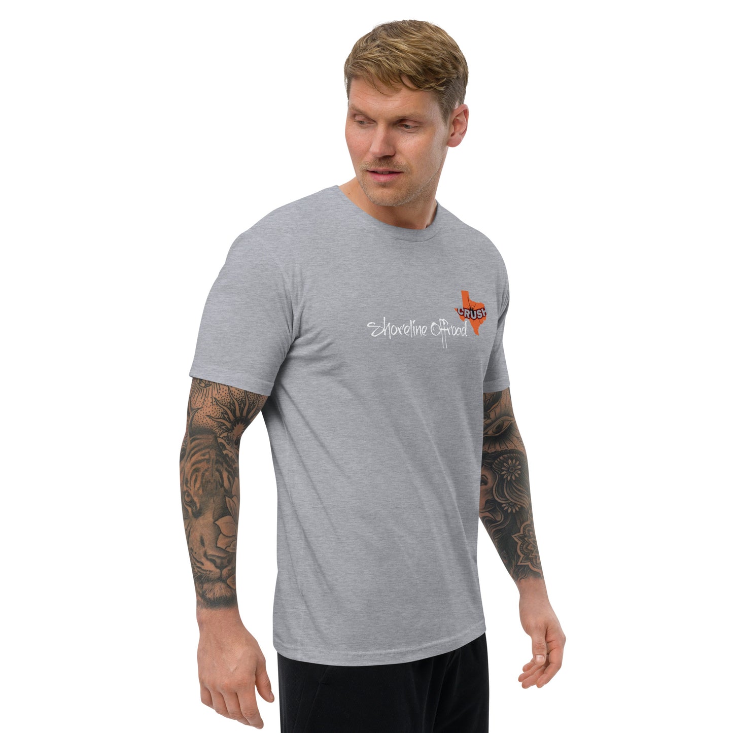 a man wearing a grey shirt with a tattoo on his arm