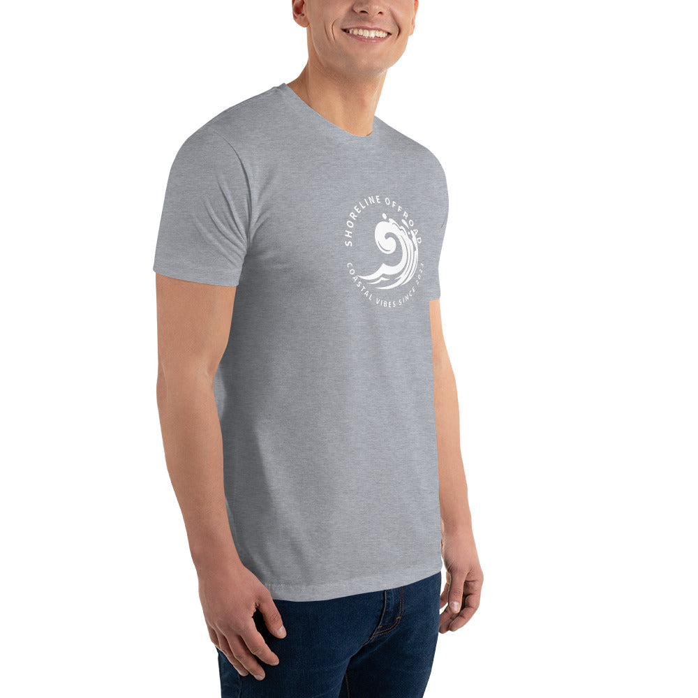 a man wearing a grey t - shirt with a white logo