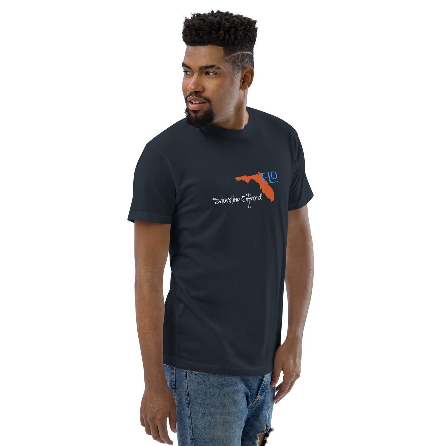a man wearing a black t - shirt with an orange gun on it