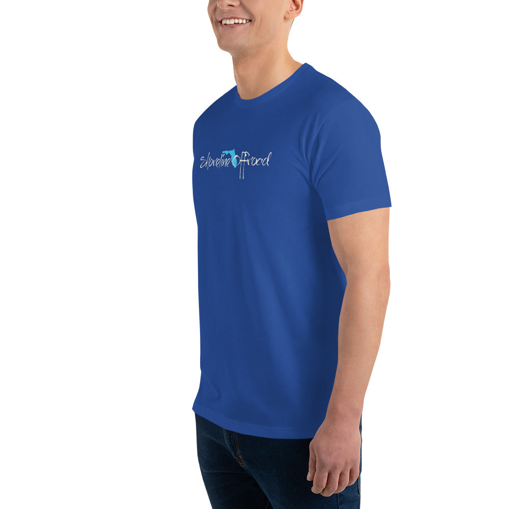 a man in a blue shirt smiles at the camera