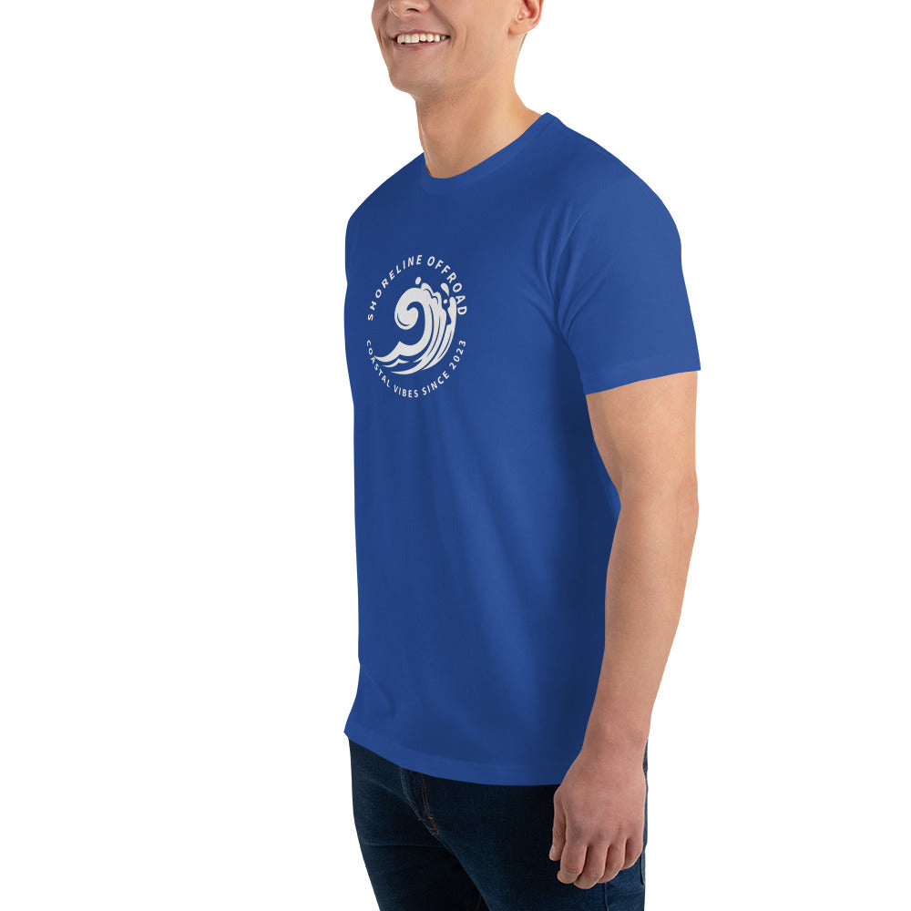 a man wearing a blue t - shirt with a white wave on it