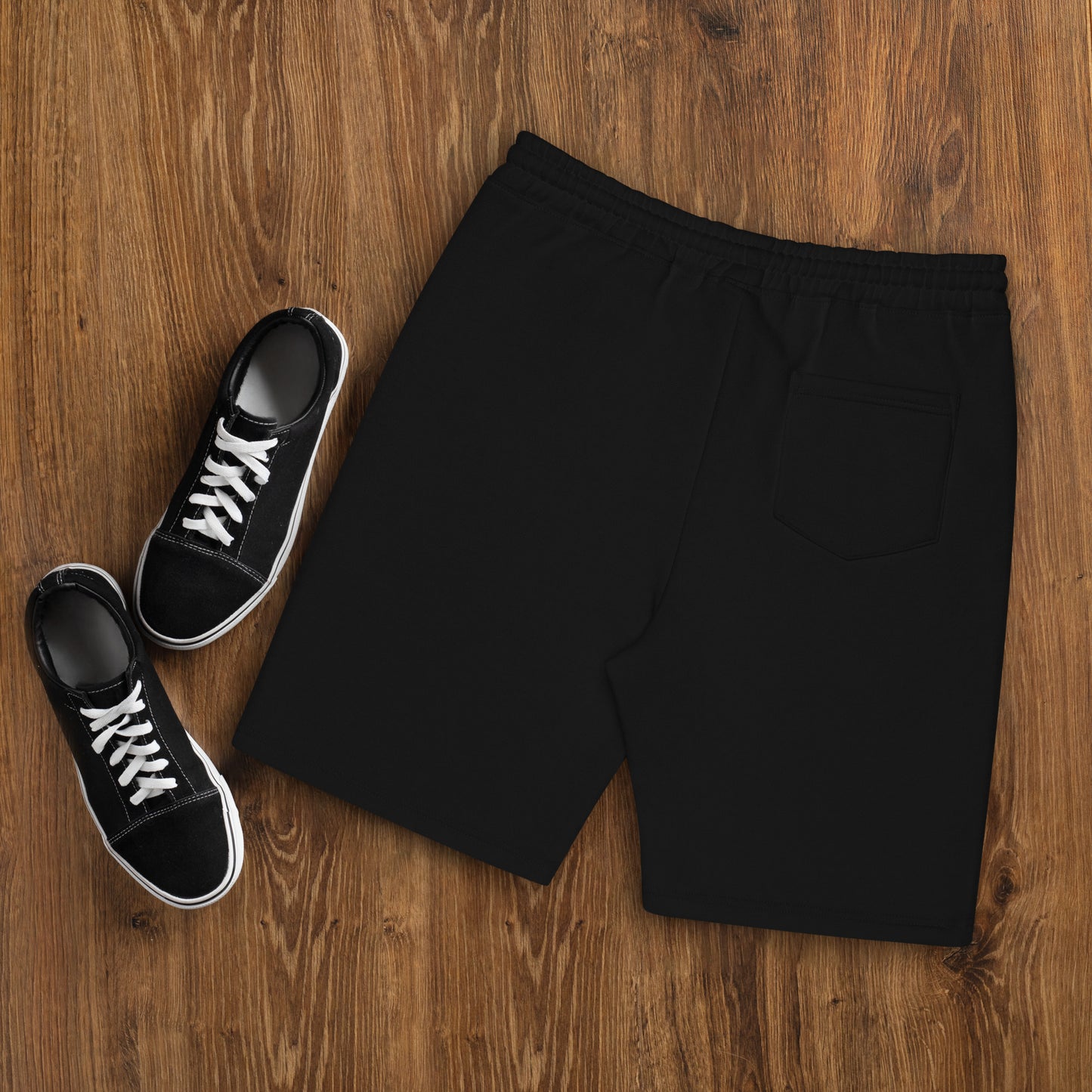 a pair of black sneakers and a pair of black shorts